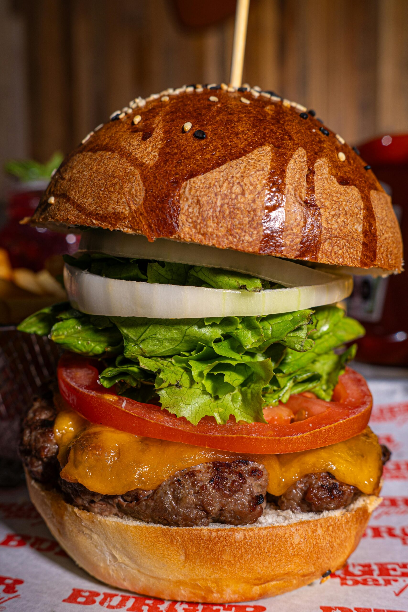 pexels photo 31176082 31176082 Mouth-watering gourmet cheeseburger with fresh lettuce, tomato, and onion rings.